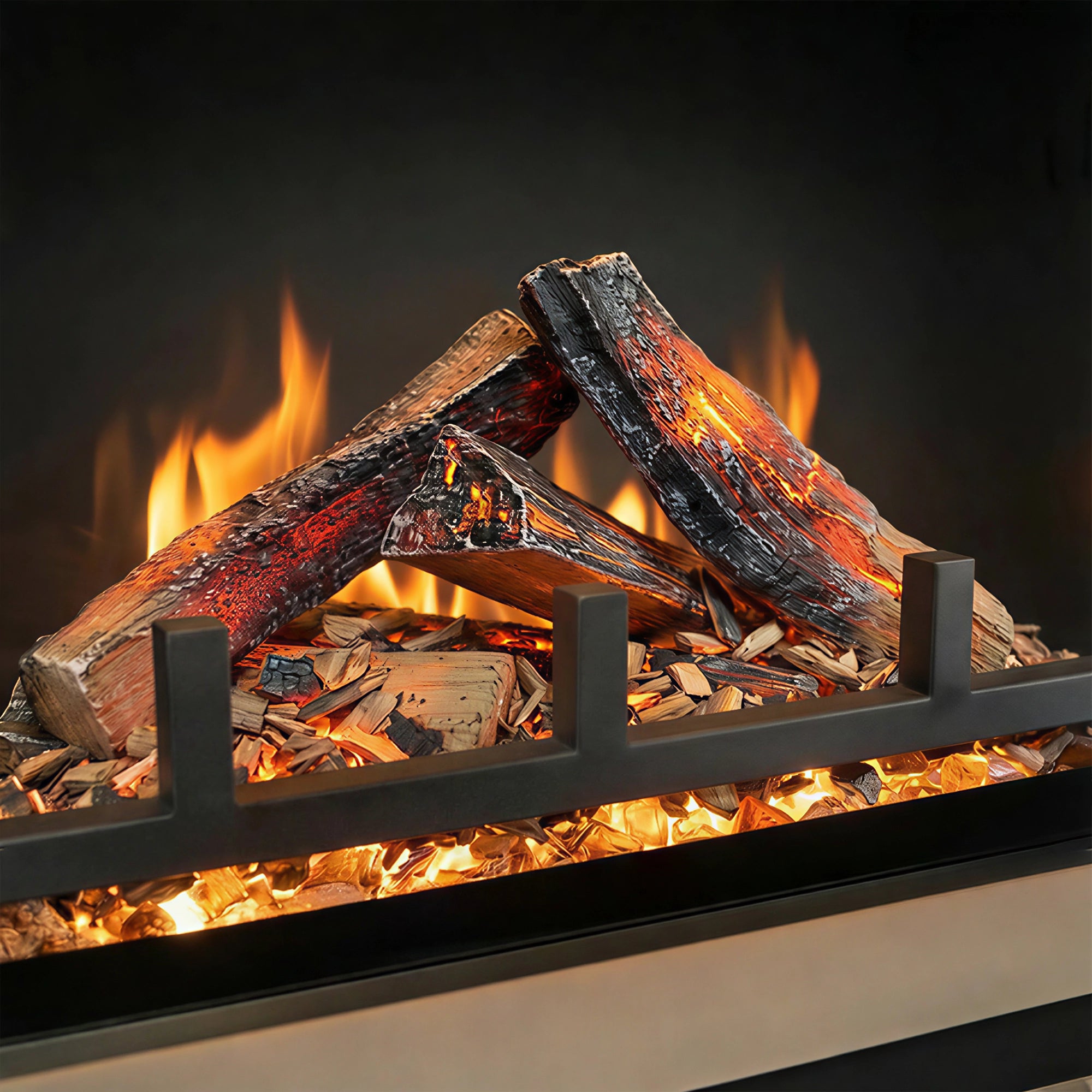 Close-up of a fireplace with burning wood and flames against a dark background